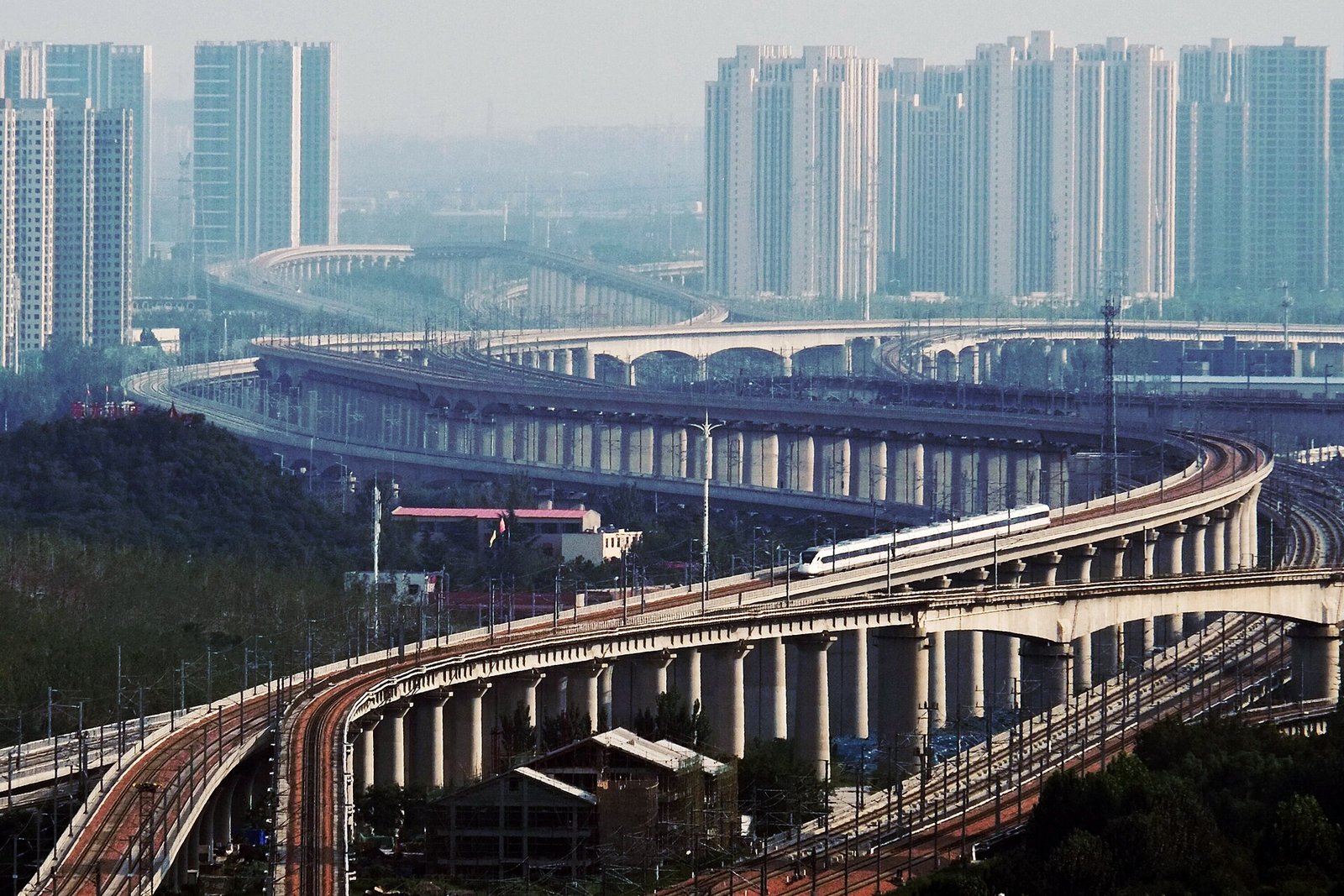 Railway viaducts south of Zhengzhou East station with residential towers in the background