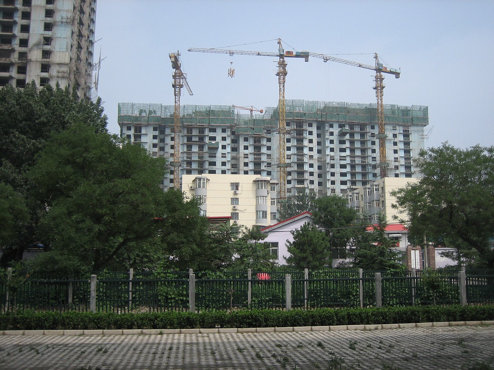 Residential apartment towers under construction with tower cranes in China